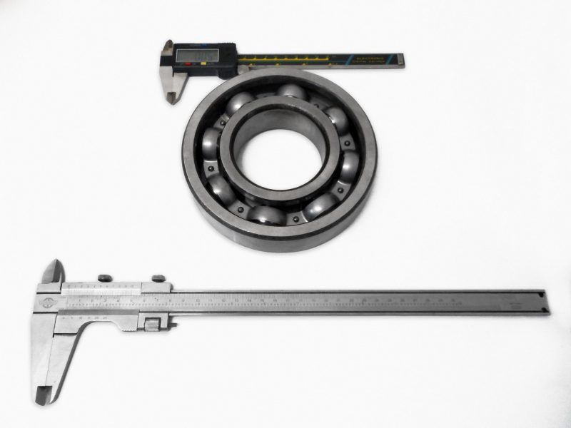 Two verniers one smaller and one larger with a deep groove ball bearing in the center